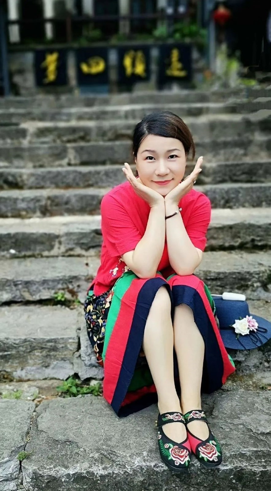 A picture containing ground, outdoor, person, sitting Description automatically generated